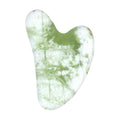 Xiuyan jade gua sha stone in pale green, heart-shaped facial massage tool