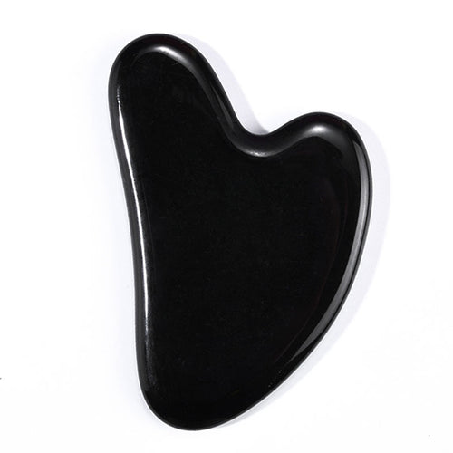 Polished black obsidian gua sha with mirror finish, heart-shaped facial massage tool