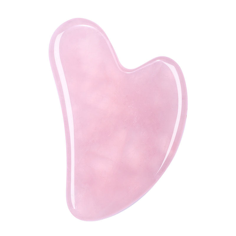 Soft pink crystal gua sha stone, semi-translucent heart-shaped facial massage tool