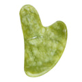 Warm-toned southern jade gua sha stone with green and honey veining, heart-shaped facial massage tool