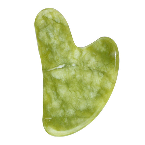 Warm-toned jade gua sha stone with green and honey veining, heart-shaped facial massage tool