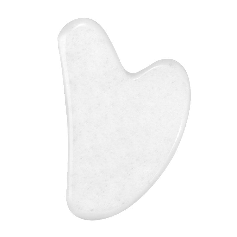 Creamy white jade gua sha stone with faint grey veining, traditional heart-shaped facial massage tool